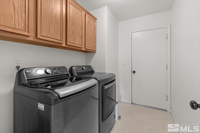 washroom featuring cabinets and washer and dryer