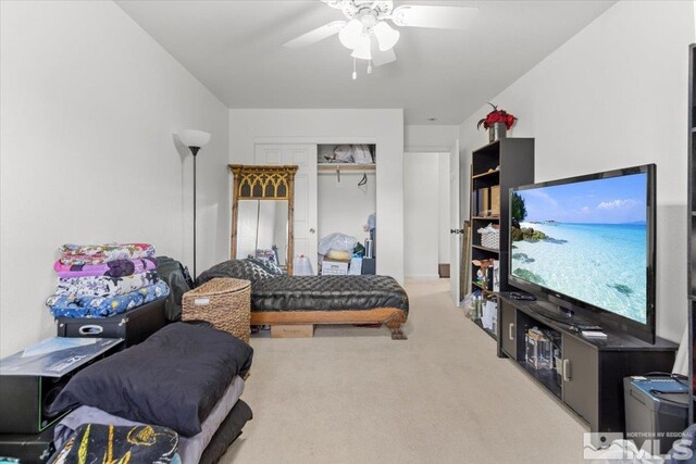 carpeted bedroom featuring ceiling fan and a closet