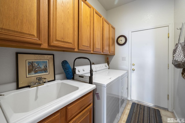 clothes washing area with sink, cabinets, and independent washer and dryer