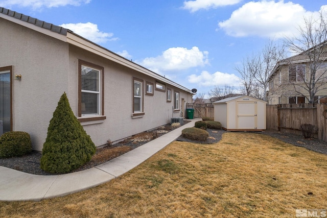 view of home's exterior featuring a lawn and a storage unit