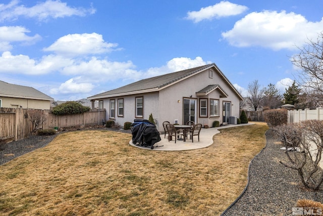 rear view of house with a yard and a patio area