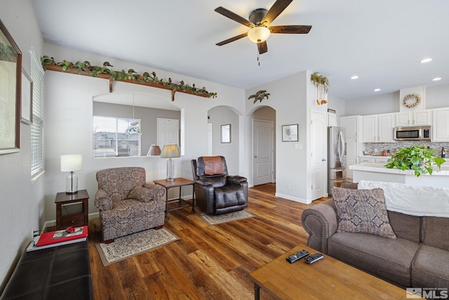 living room with dark hardwood / wood-style floors and ceiling fan