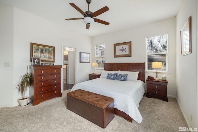 carpeted bedroom featuring ensuite bath and ceiling fan