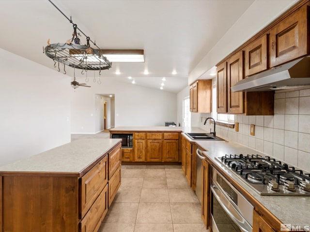 kitchen featuring sink, light tile patterned floors, stainless steel appliances, tasteful backsplash, and vaulted ceiling