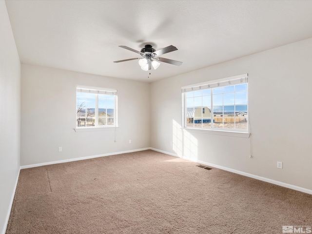 carpeted empty room with ceiling fan