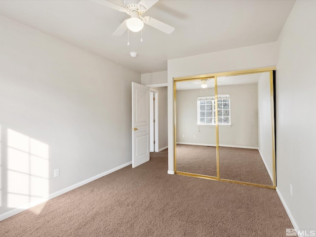 unfurnished bedroom with ceiling fan, dark carpet, and a closet