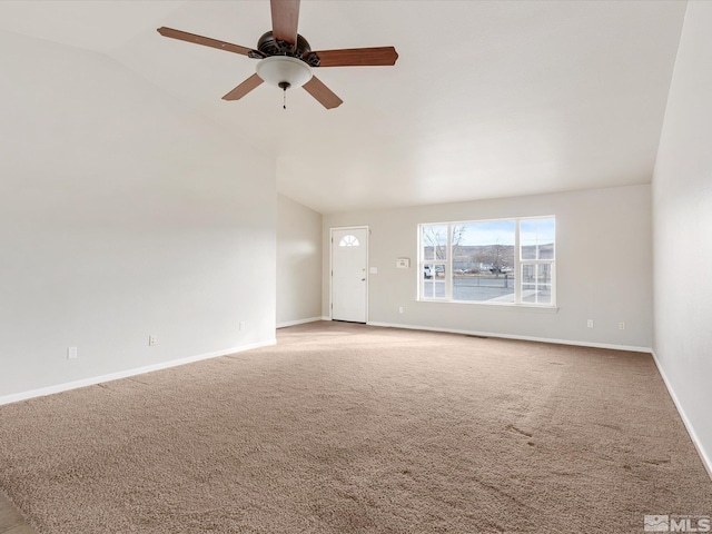 unfurnished living room featuring vaulted ceiling, ceiling fan, and carpet floors