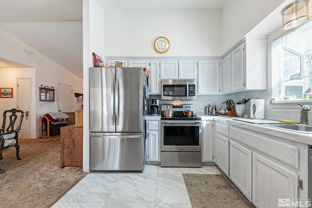 kitchen with high vaulted ceiling, stainless steel appliances, and sink