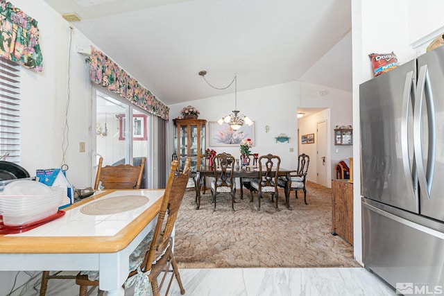 dining room with an inviting chandelier and lofted ceiling