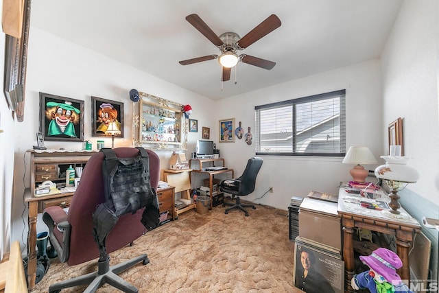 carpeted office space with ceiling fan