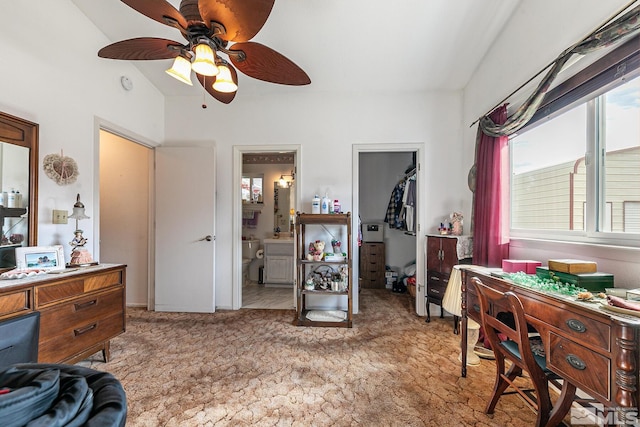 bedroom with vaulted ceiling, ensuite bathroom, light carpet, a walk in closet, and a closet