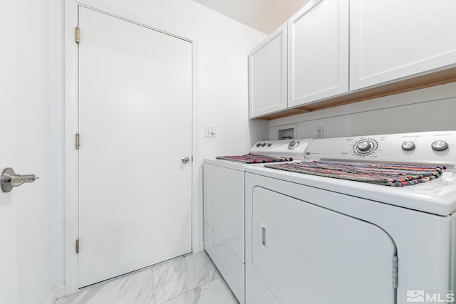 laundry area with washing machine and dryer and cabinets