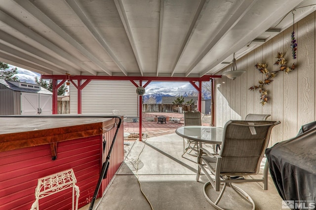 view of patio / terrace featuring a storage unit and a mountain view