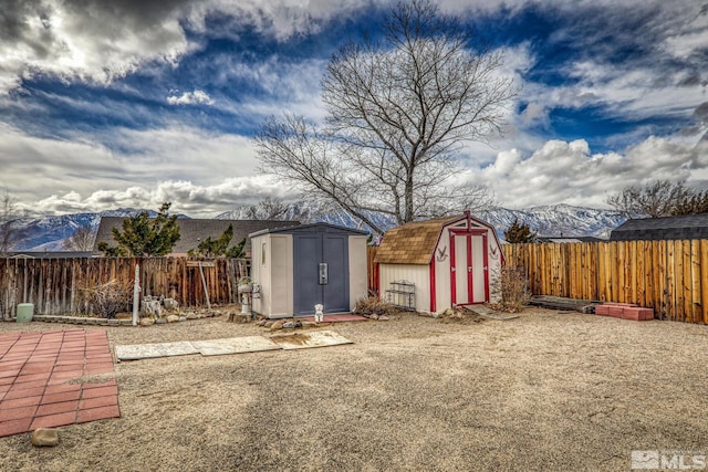 view of yard with a storage unit and a mountain view