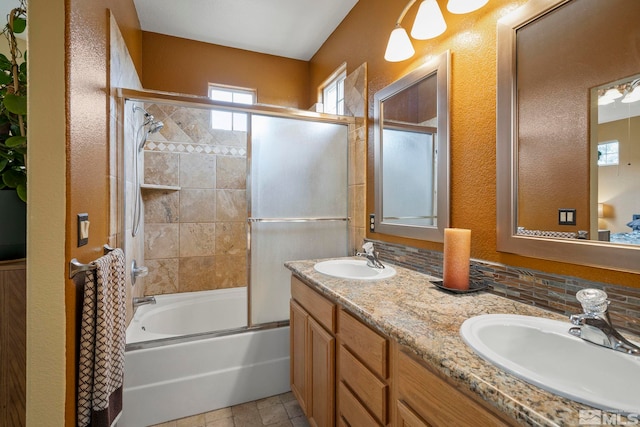 bathroom with vanity and bath / shower combo with glass door