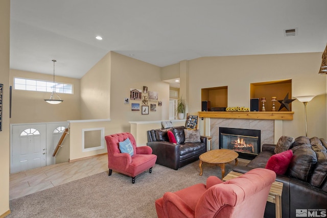 carpeted living room featuring a fireplace and vaulted ceiling