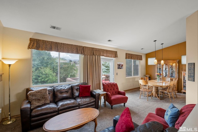 living room with vaulted ceiling and carpet flooring