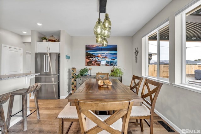 dining area with light hardwood / wood-style floors