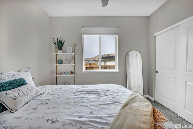 bedroom with ceiling fan, carpet flooring, and a closet