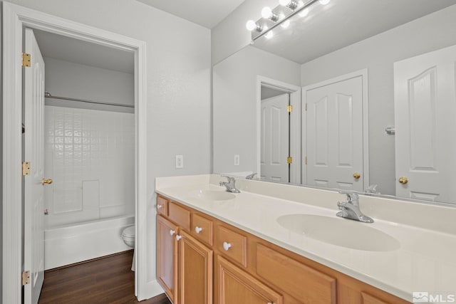 full bathroom featuring hardwood / wood-style flooring, vanity, toilet, and bathing tub / shower combination