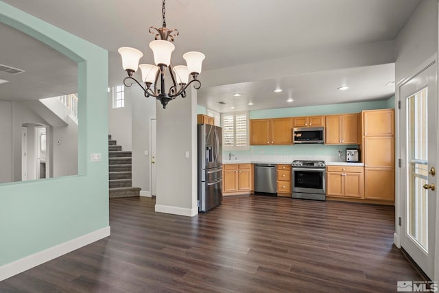 kitchen with pendant lighting, sink, a notable chandelier, stainless steel appliances, and dark wood-type flooring