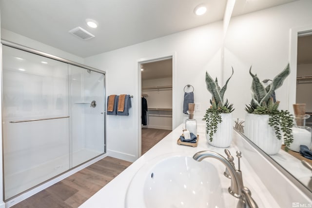 bathroom with vanity, hardwood / wood-style floors, and a shower with shower door