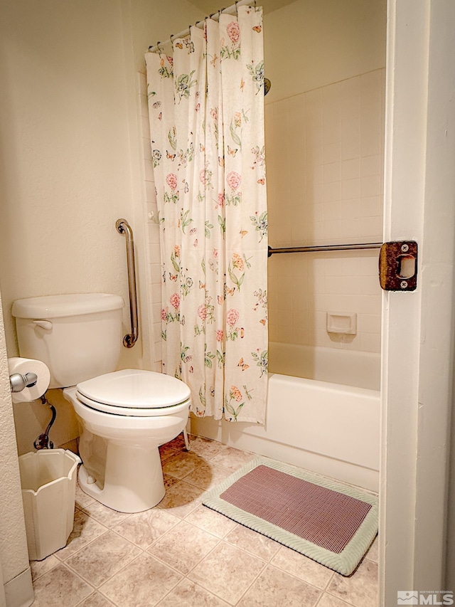 bathroom featuring shower / bath combo, tile patterned floors, and toilet