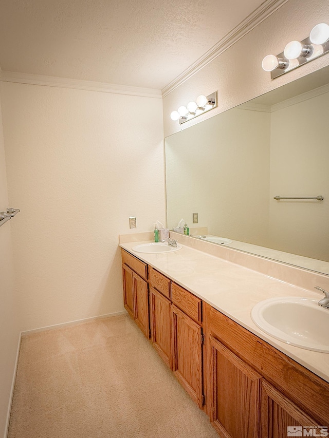 bathroom featuring vanity, ornamental molding, and a textured ceiling