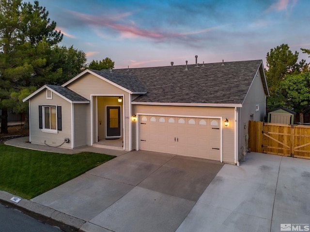 single story home featuring a garage and a yard