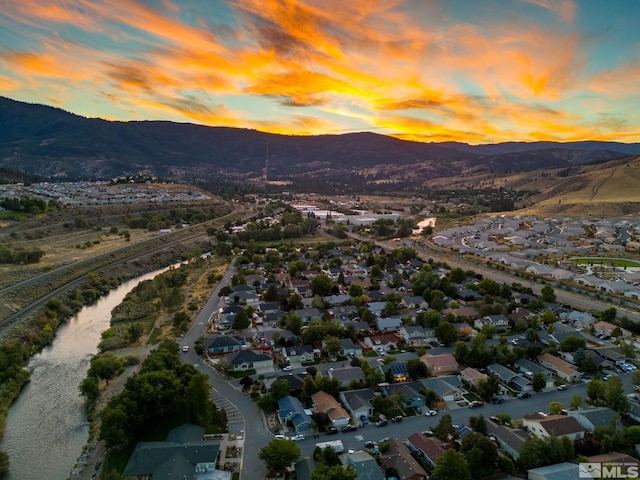 aerial view at dusk with a water and mountain view