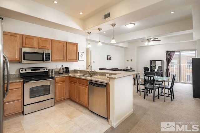 kitchen with pendant lighting, sink, ceiling fan, stainless steel appliances, and kitchen peninsula