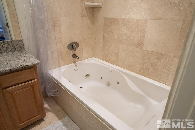 bathroom with vanity, tile patterned floors, and tiled shower / bath