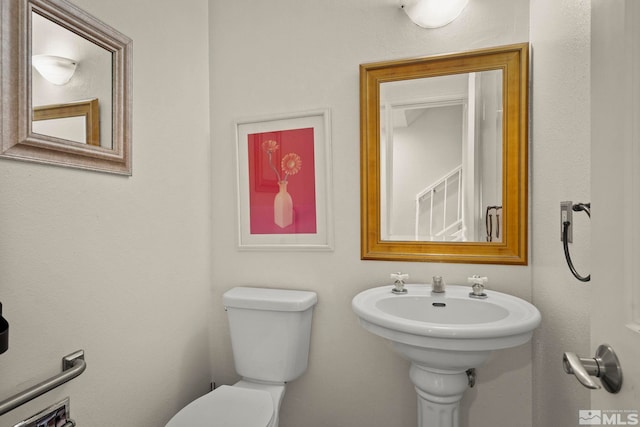 bathroom featuring sink and toilet