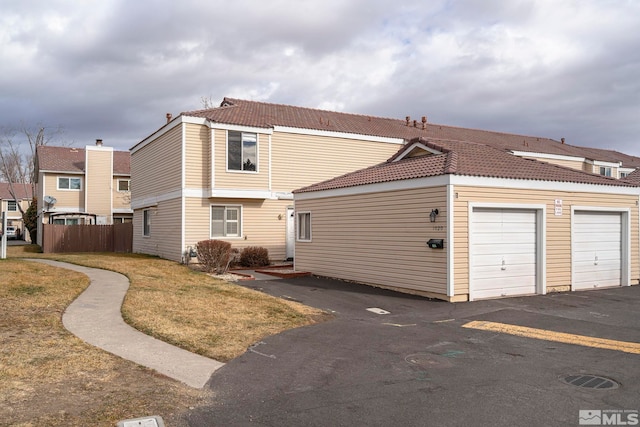 exterior space with a garage and a yard