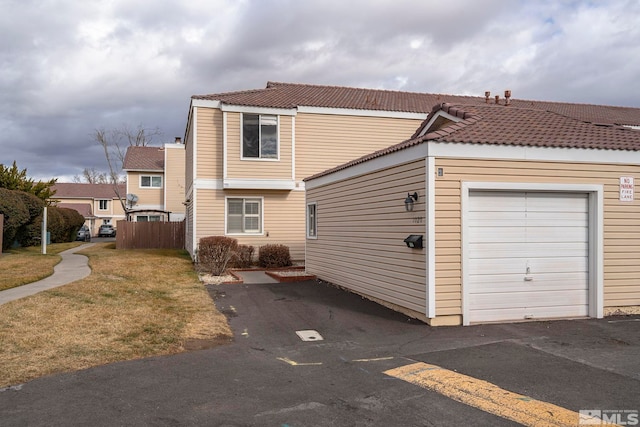 view of front facade with a garage and a front lawn