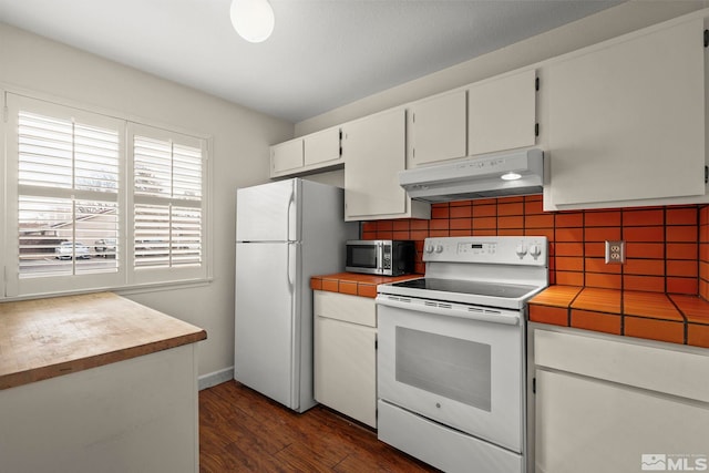 kitchen with white appliances, dark hardwood / wood-style floors, decorative backsplash, and white cabinets