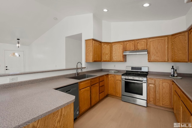 kitchen with sink, stainless steel gas stove, black dishwasher, vaulted ceiling, and kitchen peninsula