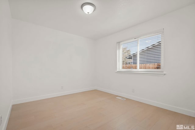 spare room featuring light hardwood / wood-style floors