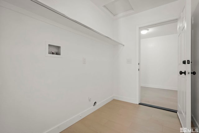 laundry area with hookup for a washing machine and light hardwood / wood-style flooring