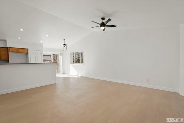 unfurnished living room featuring ceiling fan, lofted ceiling, and light hardwood / wood-style floors