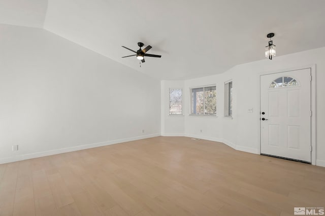 entrance foyer featuring ceiling fan, vaulted ceiling, and light wood-type flooring