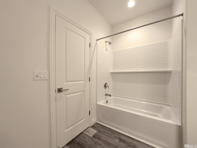 bathroom with wood-type flooring and tub / shower combination