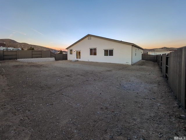 back house at dusk with a mountain view