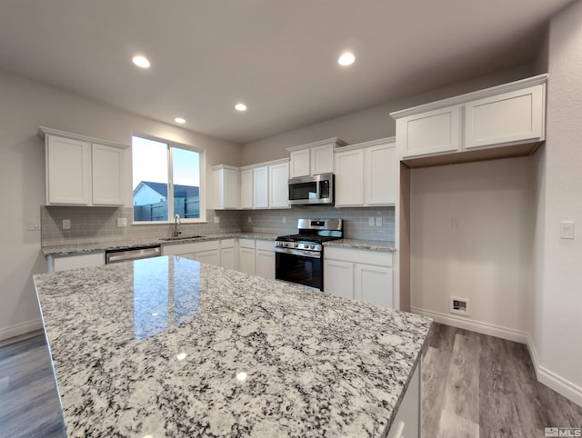 kitchen with a center island, white cabinets, and appliances with stainless steel finishes