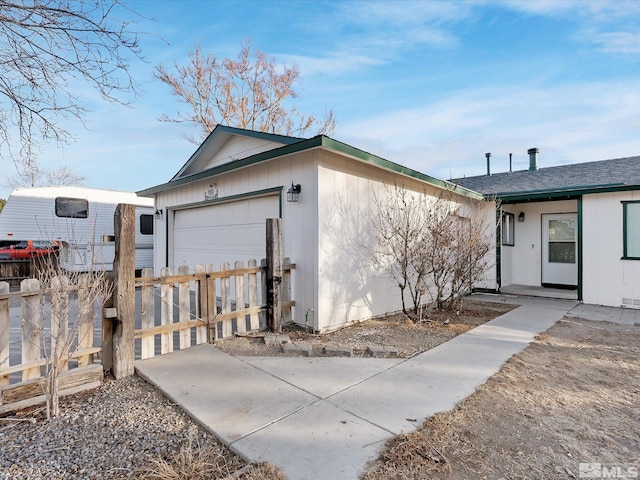 view of side of home featuring a garage