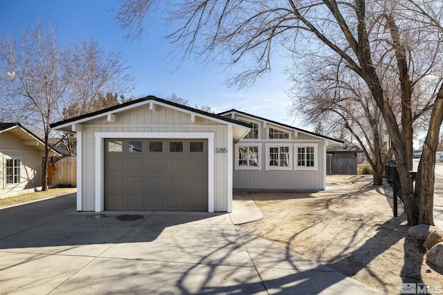 single story home featuring a garage and an outdoor structure