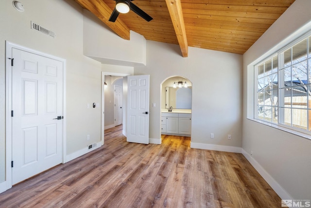 unfurnished bedroom featuring wooden ceiling, light hardwood / wood-style flooring, and vaulted ceiling with beams