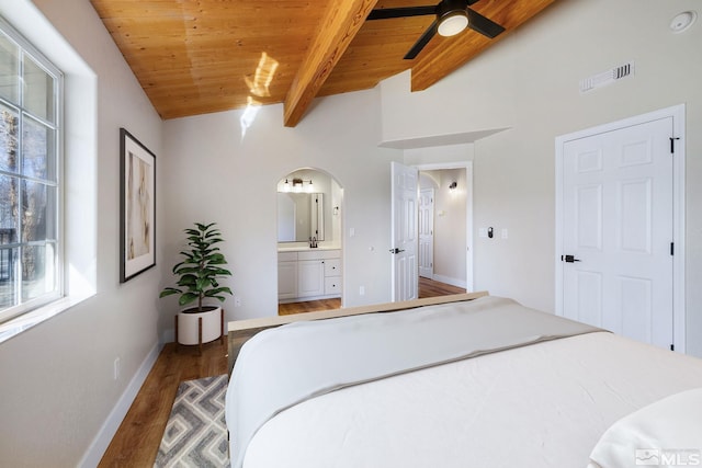 bedroom with vaulted ceiling with beams, connected bathroom, dark hardwood / wood-style flooring, and wooden ceiling