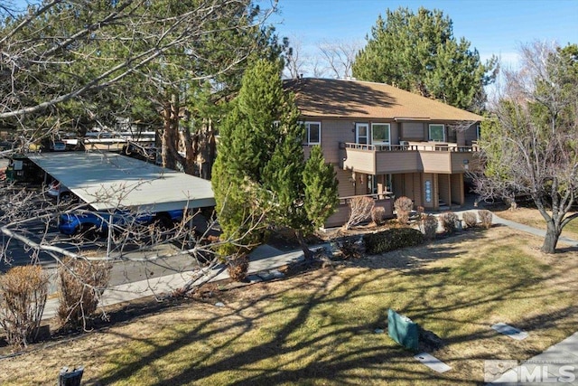 rear view of property featuring a lawn