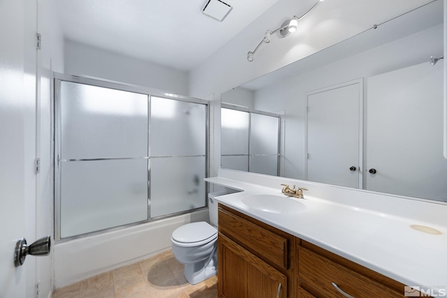 full bathroom with toilet, vanity, and bath / shower combo with glass door